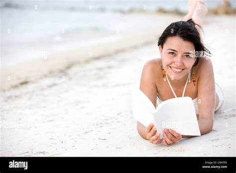 Happy Young Woman In A Bikini Lying At The Beach Fotos Und