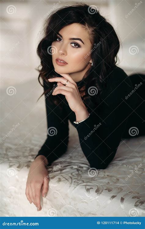 Gorgeous Brunette With Makeup And Wavy Hair Posing On Bed Stock Photo Image Of Fashion Style