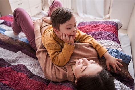Mom Enjoying Time With Her Son While Laying At The Bed And Looking At Him Stock Image Image