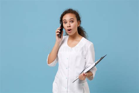 Shocked African American Female Doctor Woman In White Gown Hold Medical Document Talking On
