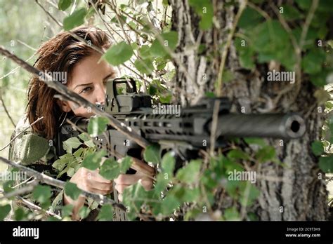 Beautiful And Attractive Woman Soldier Shooting With Rifle Machine Gun