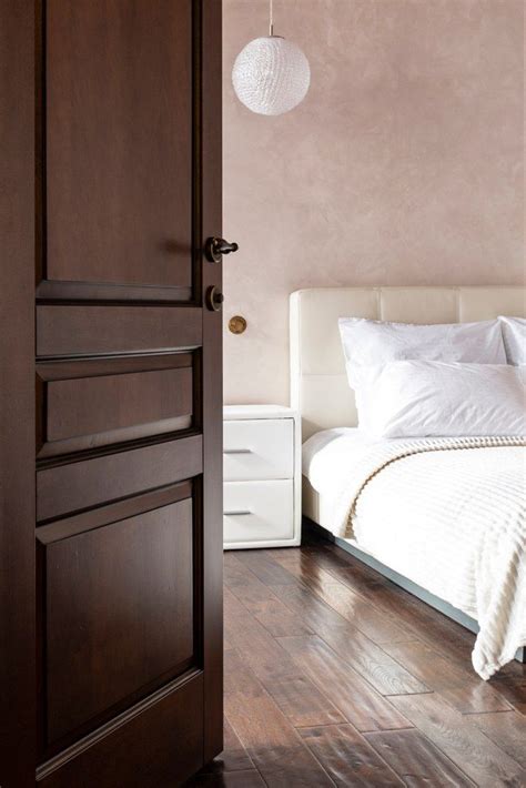 White Bedroom Through An Opened Door In An Apartment Bedroomdesign