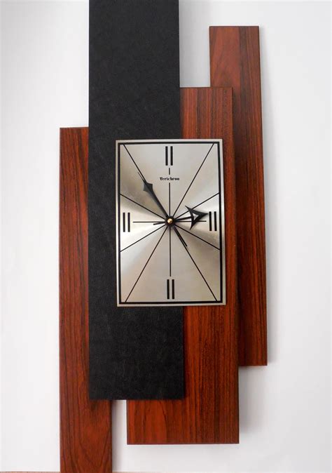 A Square Clock Mounted On The Side Of A Wall
