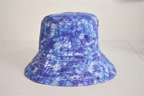 a unique wide brimmed reversible bucket hat made of a bright etsy