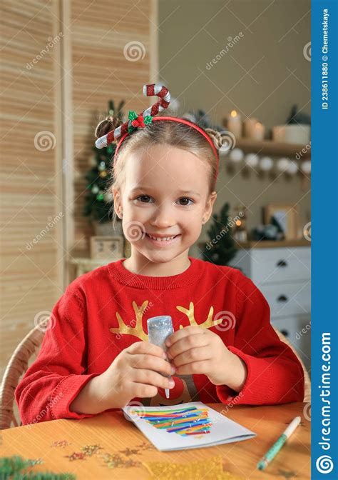 Cute Little Child Making Beautiful Christmas Greeting Card At Home