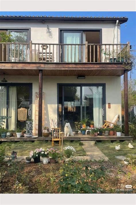 A House That Has Some Plants In Front Of It