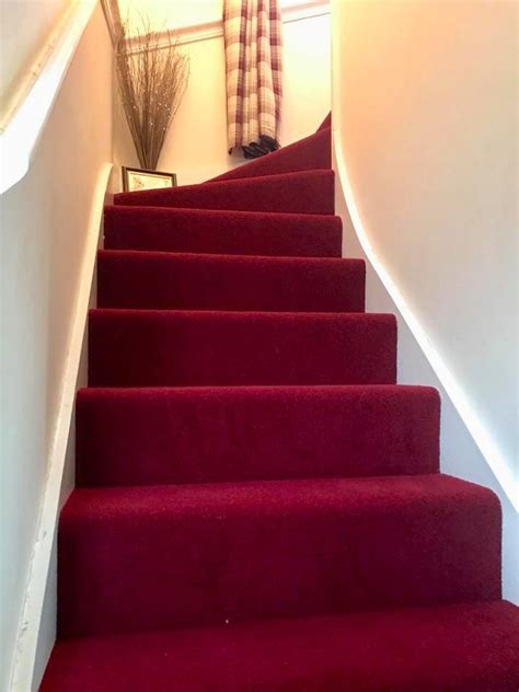Red Carpeted Stairs Leading Up To A Window