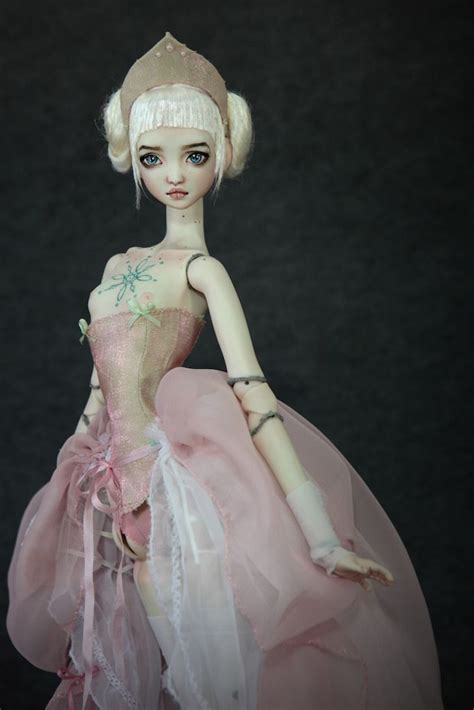 A Doll Wearing A Pink Dress And Tiara