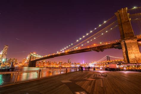 Lighted Bridge Over Water During Night Time Photo Free Image On Unsplash