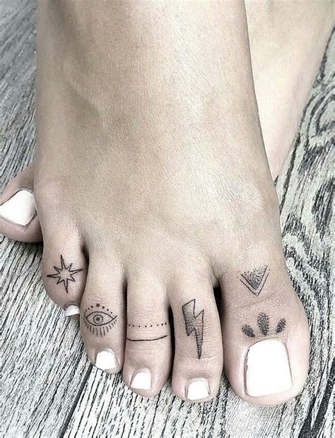 A Womans Foot With Two Different Tattoos On It