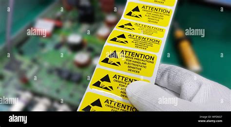 Hand Holding Esd Symbol Label With Antistatic Gloveselectrostatic