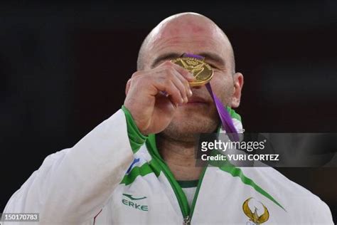 Gold Medallist Uzbekistans Artur Taymazov Poses On The Podium Of The