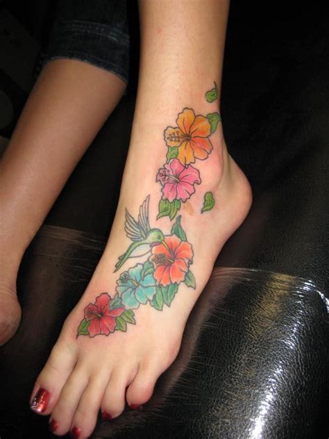 Colored Hummingbird And Flower Tattoos On Left Foot