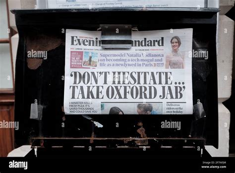 the london evening standard clipped on to a news stand with headline don t hesitate take
