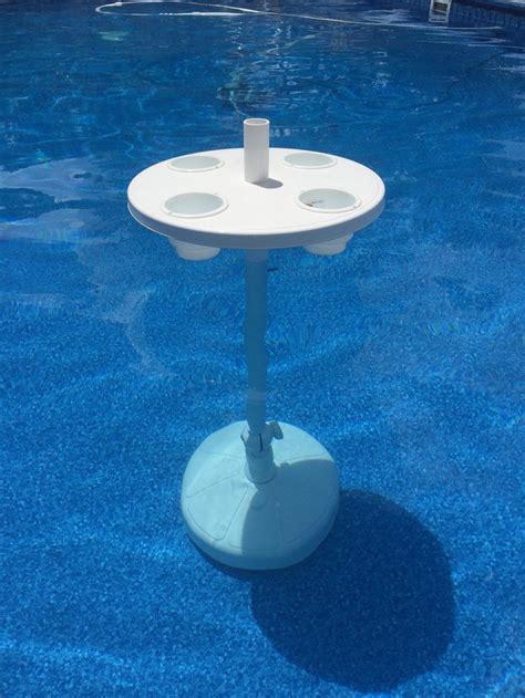 This pool umbrella is made of rustproof and weatherproof fabric. Relaxation Station Adjustable Table for Swimming Pool and umbrella | Pool umbrellas, Swimming ...