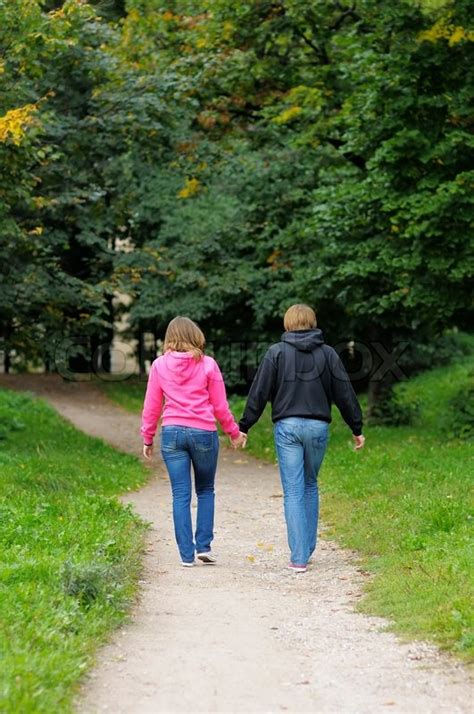 Young Couple Walking In Autumnal Park Stock Image Colourbox