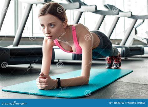 Young Girl In Gym Healthy Lifestyle Standing In Plank Pose On Mat Concentrated Close Up Stock