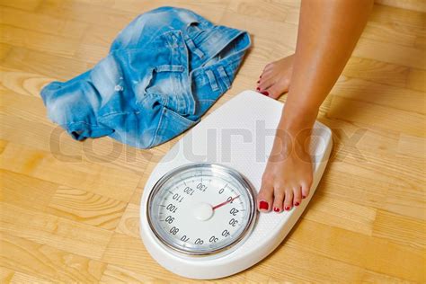 The Feet Of A Woman Standing On Scales Stock Image Colourbox