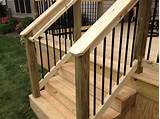 A 2x4 mounted vertically, on the outside of the posts. black aluminum spindles and graspable handrail | Deck ...