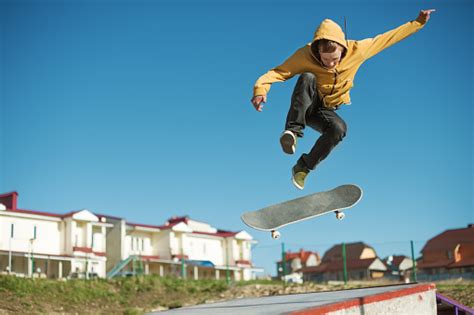 A Teenager Skateboarder Does An Flip Trick In A Skatepark
