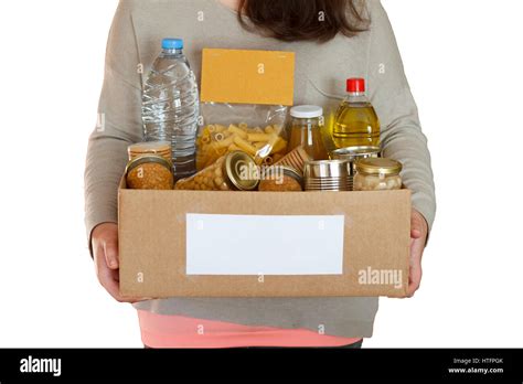 Volunteer Holding Food In A Donation Cardboard Box Isolated In A White