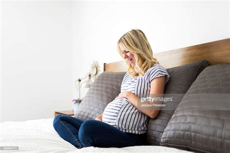 Portrait Of Pregnant Woman Touching Belly Photo Getty Images