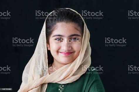 adorable happy smiling pakistani muslim girl with beautiful eyes wearing hijab and traditional