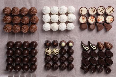 Many Delicious Chocolate Candies On Table Flat Lay Production Line