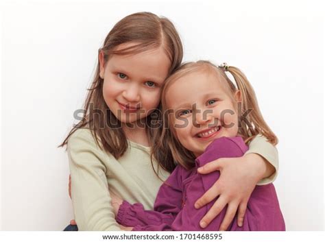 Two Little Sisters Hugging Each Other Stock Photo 1701468595 Shutterstock