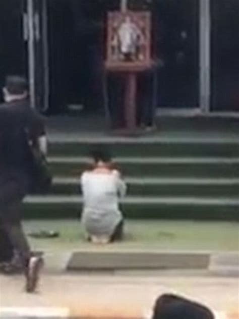 woman forced to kneel and grovel in front of jeering crowd after insulting late thai king on