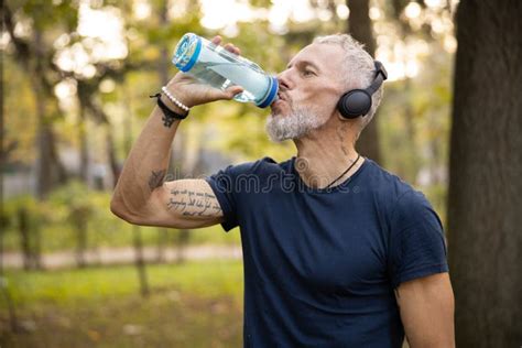 Sporty Man Drinking Water During Workout Outdoors Stock Image Image