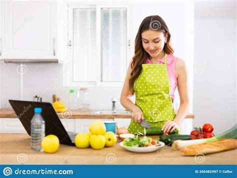 Positive Woman Cooking Dinner And Using Laptop Stock Image Image Of