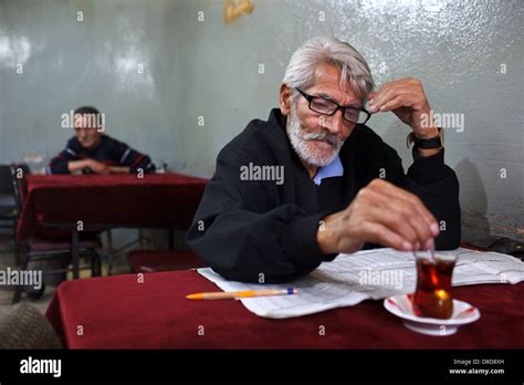 An Old Turkish Man Drinking Tea And Reading Newspaper In A Cafe Tea Shop Social Club In Balat