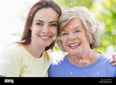 Two Women Outdoors Embracing And Smiling Stock Photo Alamy