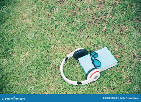 White Headphone Blue Book And Black Eye Glasses Spectacles Gadget On