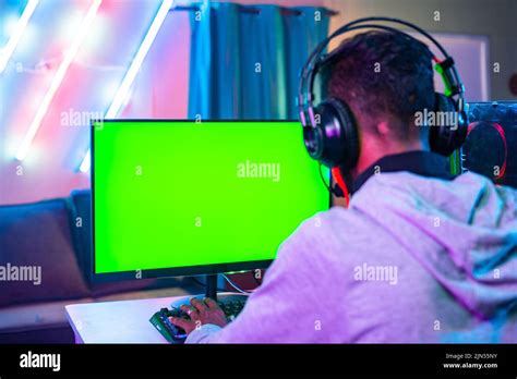 Shoulder Shot Of Professional Gamer Playing Live Video Game On Green