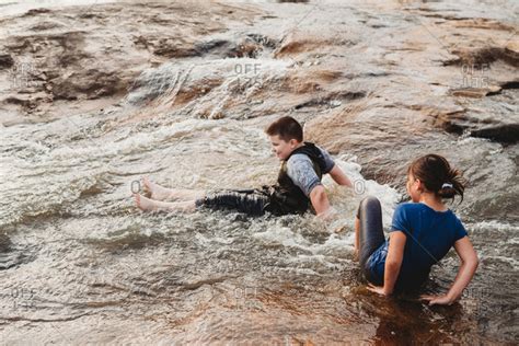 Two Kids Playing In A River Stock Photo Offset