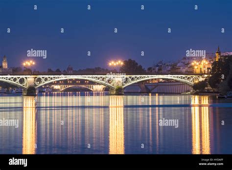 Spain Seville Triana Puente De Isobel Ii Illuminated At Dusk Stock