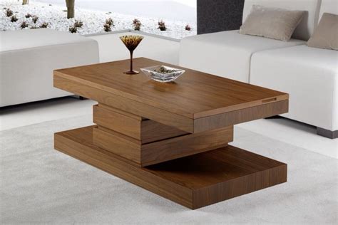 A Modern Coffee Table In The Middle Of A Living Room With White Couches