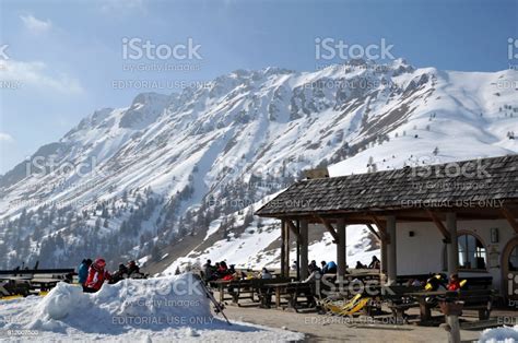 Skiers Sunbathing Outdoor At A Restaurant In The Italian Dolomites