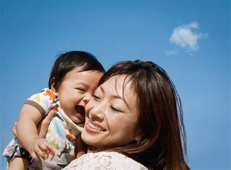 Happy Asian Mother And Baby Boy In Blue Sky By Stocksy Contributor Yuko Hirao Stocksy