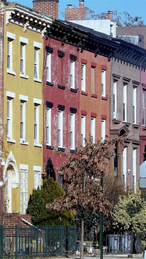 A Row Of Multi Colored Brick Buildings On A City Street