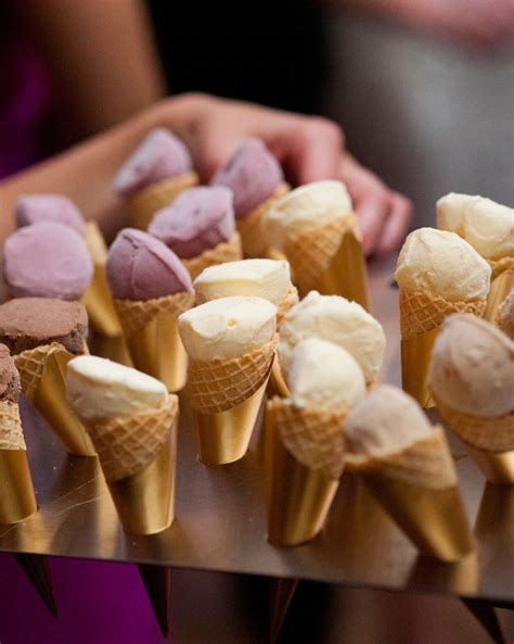 Several Cones Of Ice Cream Are Arranged On A Table