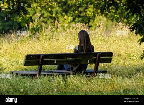 Girl Sitting Alone In A Park Bench Hi Res Stock Photography And Images