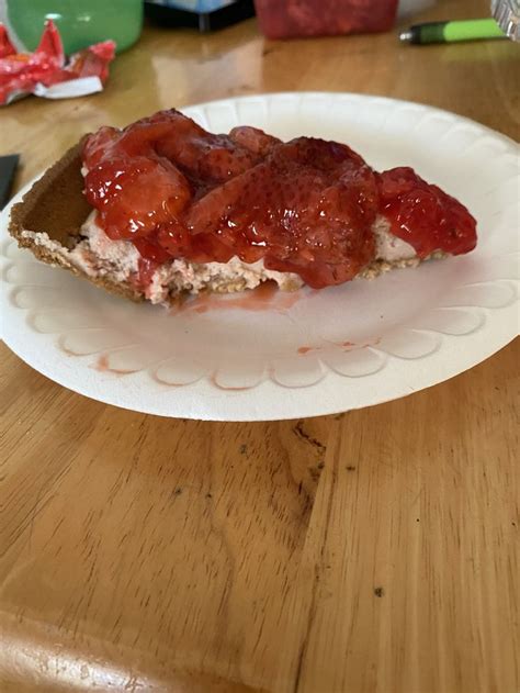 A Piece Of Bread With Strawberry Jam On It Sitting On A Table Next To A