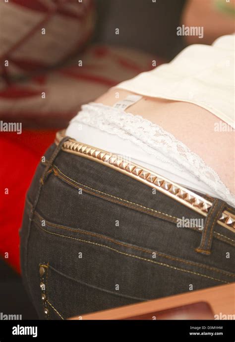 Overweight Woman Bending With Back And Underwear Showing Stock Photo