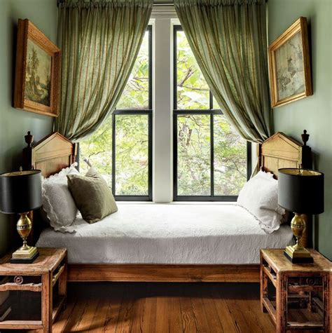 A Bed Sitting Under A Window In A Bedroom