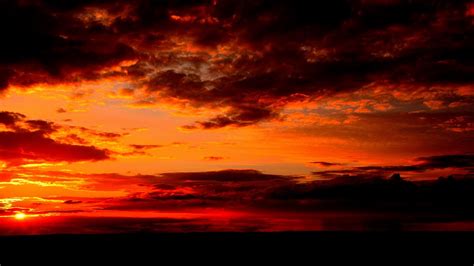Download Wallpaper 1366x768 Clouds Sunset Horizon Dark