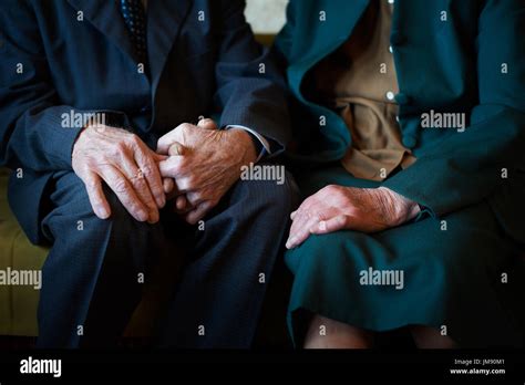 cute 80 plus year old married couple posing for a portrait in their house love forever concept
