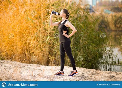 Beautiful Fitness Athlete Woman Drinking Water After Work Out